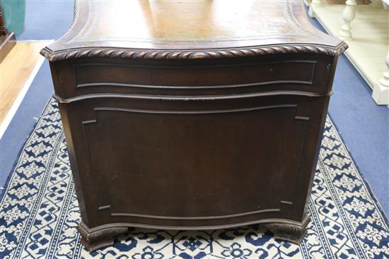 A serpentine pedestal desk, 135cm wide